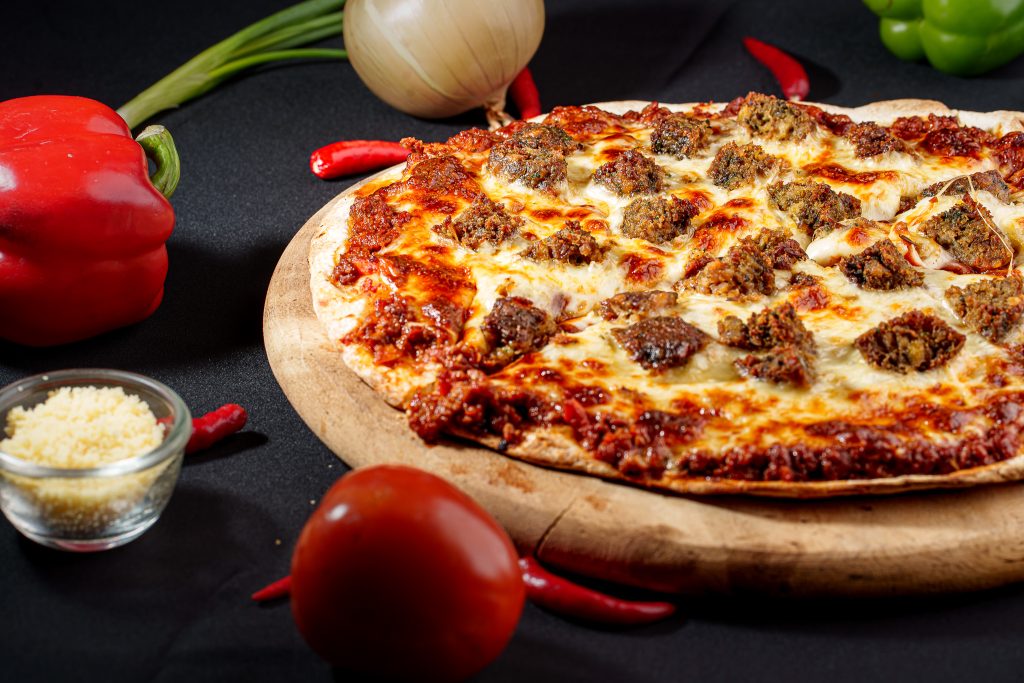Sausage pizza with melted cheese and tomato sauce.